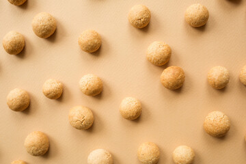 pepernoten or kruidnoten: sweet traditional dutch cookies for sinterklaas holiday - saint nicholas day. beige neutral holiday background