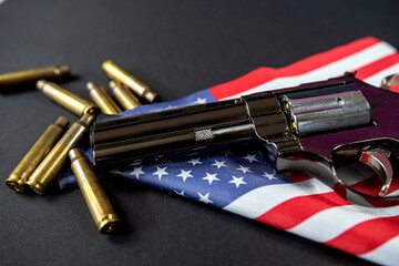 black revolver ammunition on folded united states flag is against constitution of united states