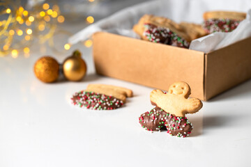 Christmas cookies . Man shape butter cookies on white background with bokeh, typical festive treat