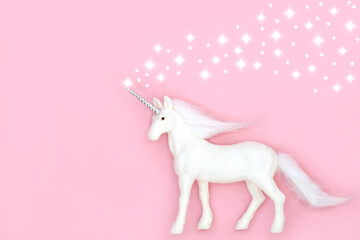 Christmas magical mythical unicorn with white stars on pink background. Festive glitter bauble tree decoration for Xmas and New Year.