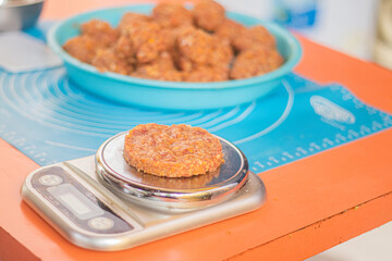 Homemade burger patty on the scales