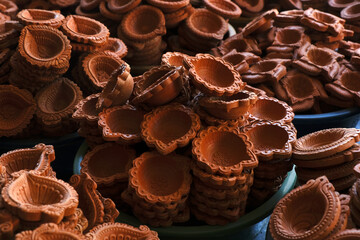 diya or clay lamp at market during Diwali festival in India.