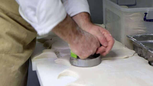 Professional production of dough blanks at restaurant kitchen, close-up 4k footage.