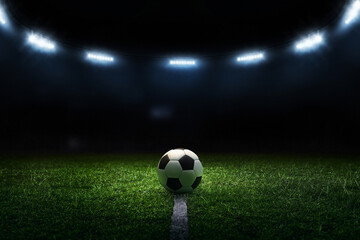 3D render soccer ball on black background. Soccer ball and bright lights with flashes at night.