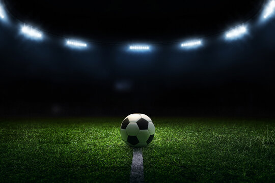 3D render soccer ball on black background. Soccer ball and bright lights with flashes at night.