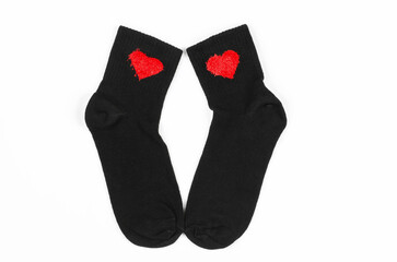 Black socks on a white background. Pair of black socks with hearts
