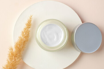 Open jar of body moisturizer. Moisturizing cream white packaging mockup. The concept of natural beauty products for spa treatments.