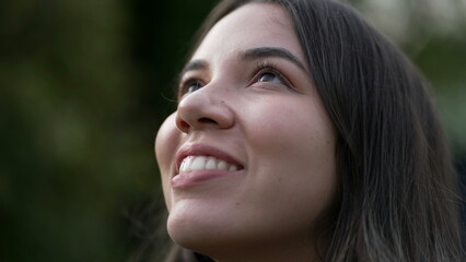 Young woman closing eyes in meditation closeup face. Person smiling with HOPE