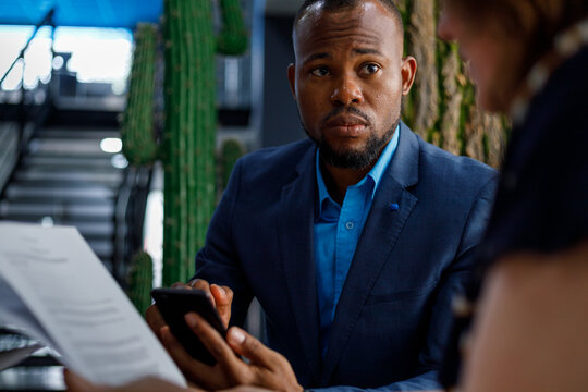 Businessman listening and looking at partner in meeting