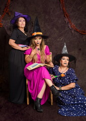 Obraz premium Studio portrait of three women of different ages dressed as witches.