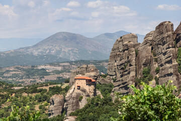 Fototapeta na wymiar The Holy Monastery of St. Nicholas Anapausas (Moni Agios Nikolaos Anapafsas) is located remotely and a little isolated from others on only 80 meters cliff, Meteora, Greece