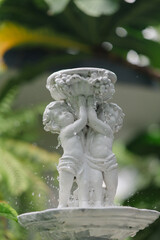 Cute baby corner antique stone doll statue, close-up of newly built home garden stone statue.