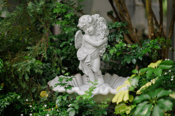 Cute baby corner antique stone doll statue, close-up of newly built home garden stone statue.