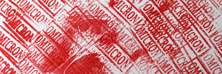 Red bloody handprint against background of omicron seals closeup