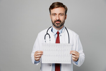 Male doctor man wears white medical gown suit work in hospital hold electrocardiogram record, heart...