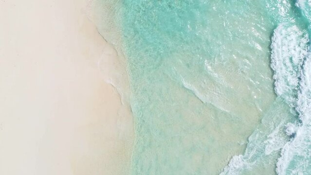 top view of crystal clear transparent water and white sand on tropical Seychelles beach.