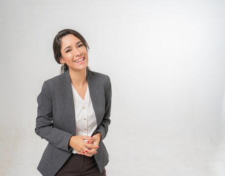 Studio portrait photo of a young beautiful elegant Brazilian female businesswoman lady wearing smart casual business attire suit posing with a series moments of emotion and gesture for all application