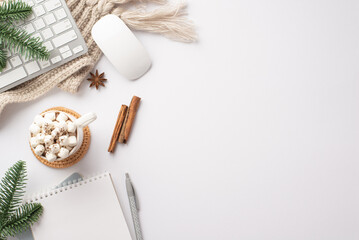 Obraz na płótnie Canvas Winter concept. Top view photo of workplace keyboard computer mouse cup of cocoa with marshmallow diaries pen pine branches cinnamon sticks anise and knitted plaid isolated white background