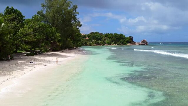 Panoramic view of tropical beach with palm trees. Thailand, Seychelles, Maldives