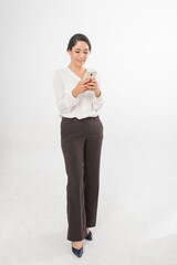 Studio portrait photo of a young beautiful elegant Brazilian female businesswoman lady wearing smart casual business attire posing with a series moments of emotion and gesture of using her smartphone