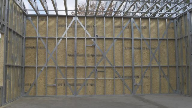 Constrained steel structure frame wall of a garage under construction 