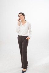 Studio portrait photo of a young beautiful elegant Brazilian female businesswoman lady wearing smart casual business attire posing with a series moments of emotion and gesture of using her smartphone