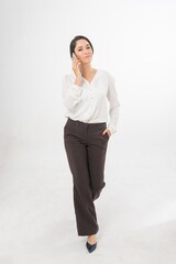 Studio portrait photo of a young beautiful elegant Brazilian female businesswoman lady wearing smart casual business attire posing with a series moments of emotion and gesture of using her smartphone