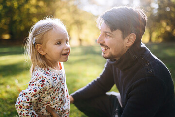 happy father with little daughter in autumn park outdoor recreation. Father and daughter