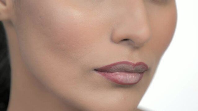Closeup Of Model Modelling Lips During Applying Cosmetic Makeup