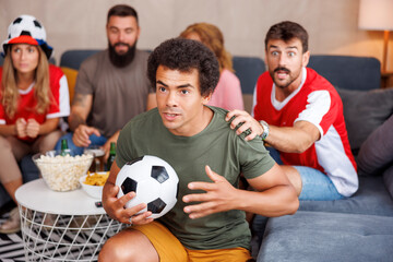 Friends watching football world championship game on TV