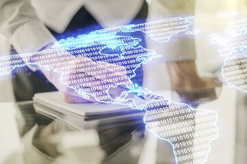 Double exposure of graphic America map and man hand writing in notepad on background, big data and digital technology concept