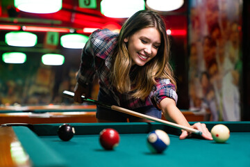 Portrait of beautiful young woman in billiard club