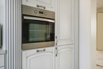 Fototapeta premium furniture and tableware on modern luxure kitchen in studio apartments in minimalistic style with light color