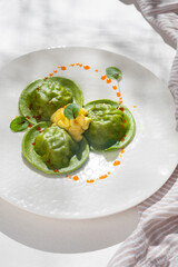 Delicious Dumplings and dill - russian pelmeni - italian ravioli - on white plate. Close up view