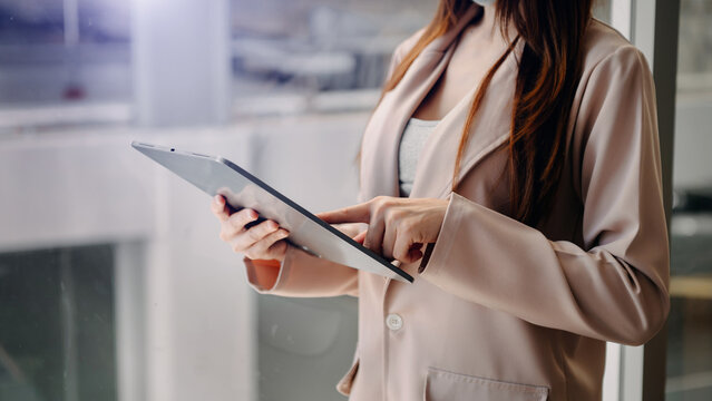 Close up image of woman holding a digital tablet online banking, internet network communication concept..