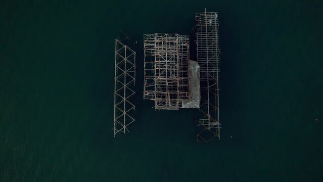 Top down drone shot of West Pier Brighton pulling back to reveal sea