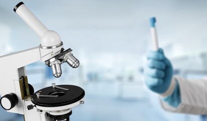 Scientist hold a sample for analysis with lab microscope