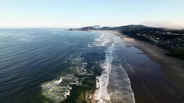 Newport, Oregon coastline in the Pacific Northwest. Crashing waves and surf along deserted beaches.