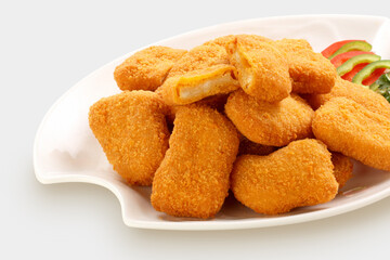 Fried chicken nuggets and sauce, isolated on gray.