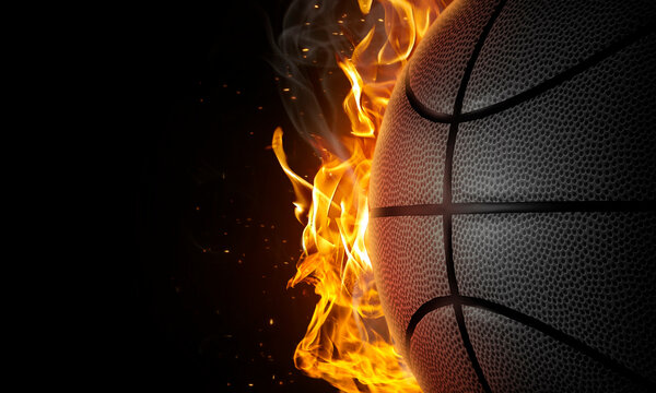 Basketball on fire on black background