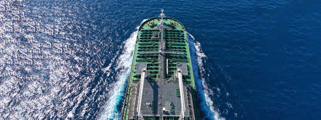 Aerial drone ultra wide panoramic photo with copy space of huge crude oil tanker cruising in open ocean deep blue sea