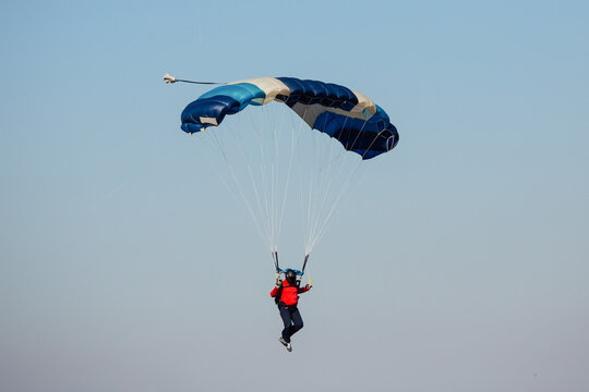 Parachute in the sky. Skydiver is flying a parachute in the blue sky.