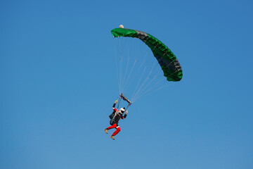 Parachute in the sky. Skydiver is flying a parachute in the blue sky.