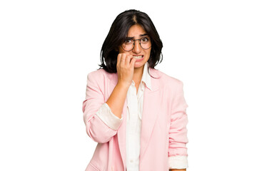 Young Indian business woman wearing a pink suit isolated biting fingernails, nervous and very anxious.