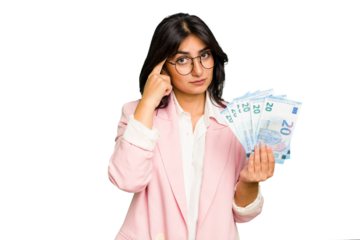 Young business Indian woman holding banknotes isolated pointing temple with finger, thinking, focused on a task.