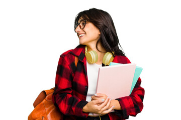 Young student Indian woman wearing headphones isolated looks aside smiling, cheerful and pleasant.