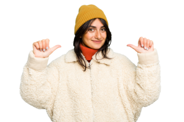 Young Indian woman wearing winter jacket and a wool cap isolated feels proud and self confident, example to follow.