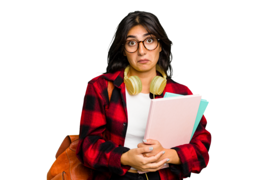 Young student Indian woman wearing headphones isolated shrugs shoulders and open eyes confused.