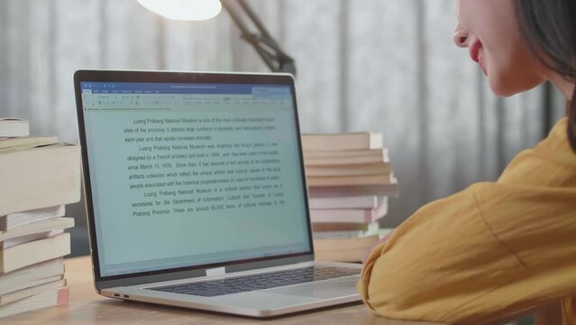 Close Up Of A Laptop Being Used By A Female To Read The Text While Studying At Home
