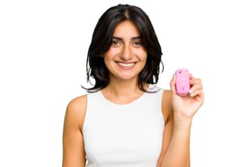 Young Indian woman holding a car keys isolated happy, smiling and cheerful.